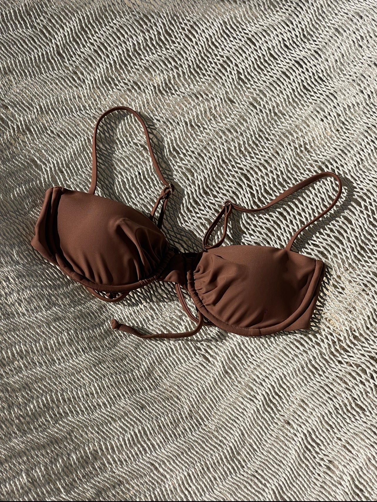 Look classy in Origin of the 6ix. A balconette design with ruched cups and underwire for more support. Achieve your desired fit with adjustable shoulder straps and back ties. Match with Origin of the 6ix bottoms in Tawny Brown.   Runs smaller to size- we suggest going up a size. Refer to size chart* Double lined with a seamless finish 85% polyester and 15% spandex Adjustable straps  Removable padding Handwash in cold water only 